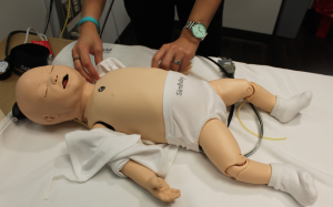 SimBaby's vital signs can be monitored with instruments, including a tiny blood pressure cuff.