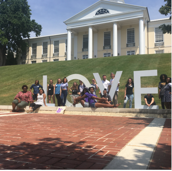 Students from Saturday pose with the LOVE sign on campus
